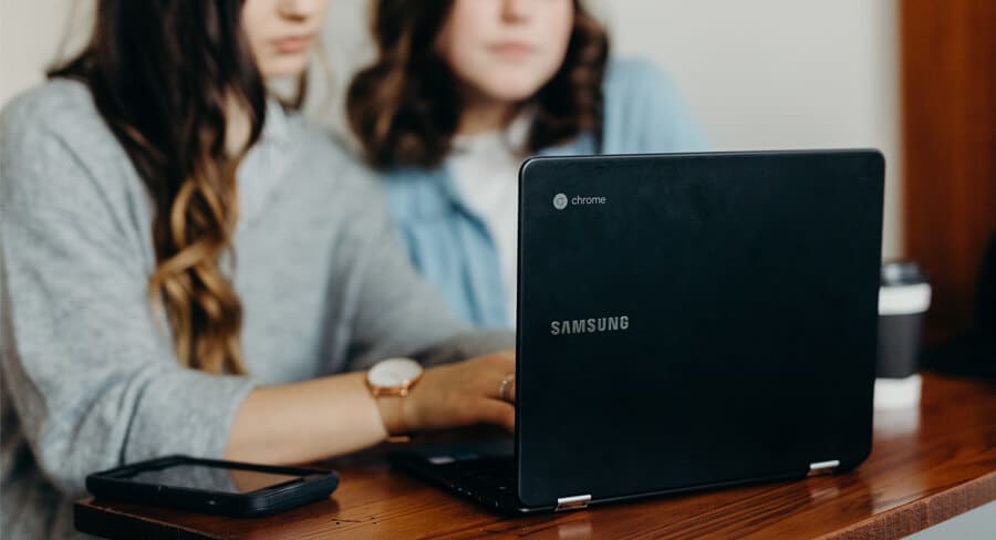 Two female students study online together